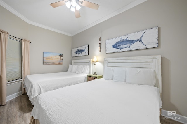 bedroom with baseboards, ornamental molding, ceiling fan, and wood finished floors