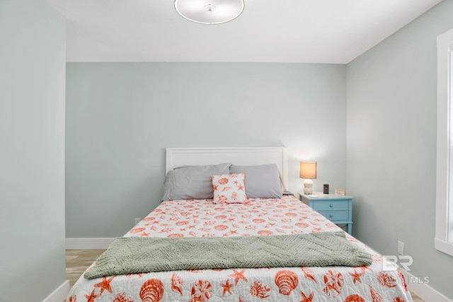 bedroom featuring baseboards and light wood-style flooring
