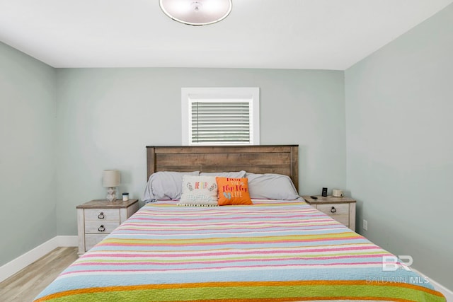 bedroom with wood finished floors and baseboards