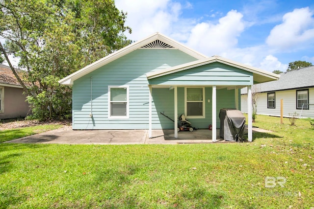 back of property with a patio and a lawn