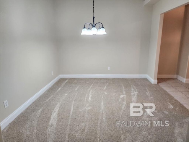 interior space featuring light tile patterned floors, baseboards, a chandelier, and light colored carpet