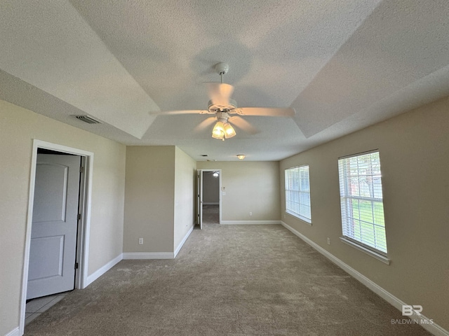 unfurnished room featuring baseboards, visible vents, and carpet flooring