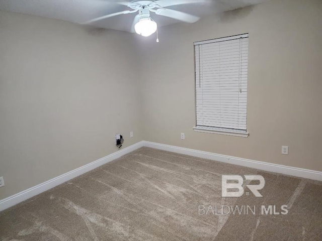 empty room featuring carpet, a ceiling fan, and baseboards