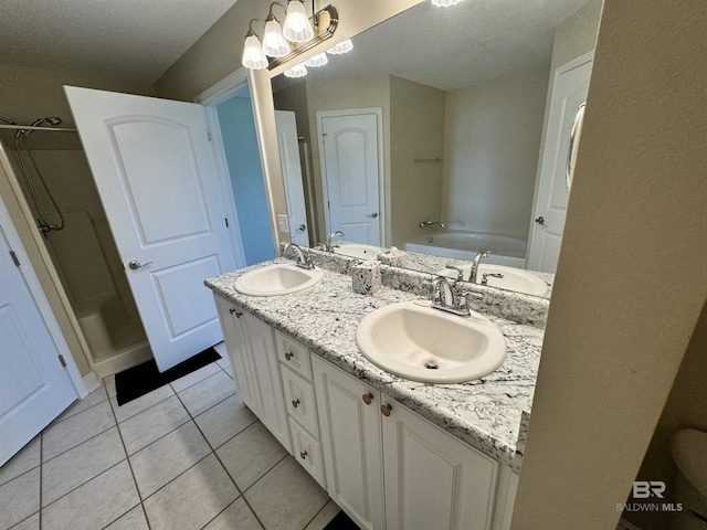 full bath featuring double vanity, tile patterned flooring, and a sink