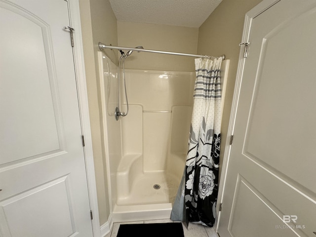 bathroom featuring a stall shower and a textured ceiling