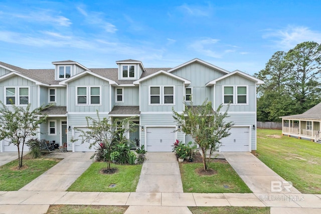 view of property with a front yard and a garage