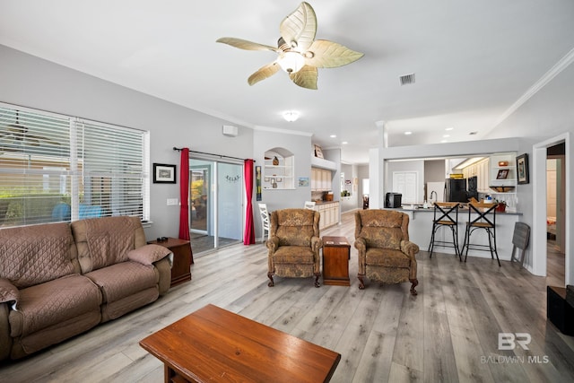 8585 Bay Harbor Rd, Elberta, AL 36530 - living area featuring light wood-style flooring, ceiling fan, ornamental molding, and recessed lighting