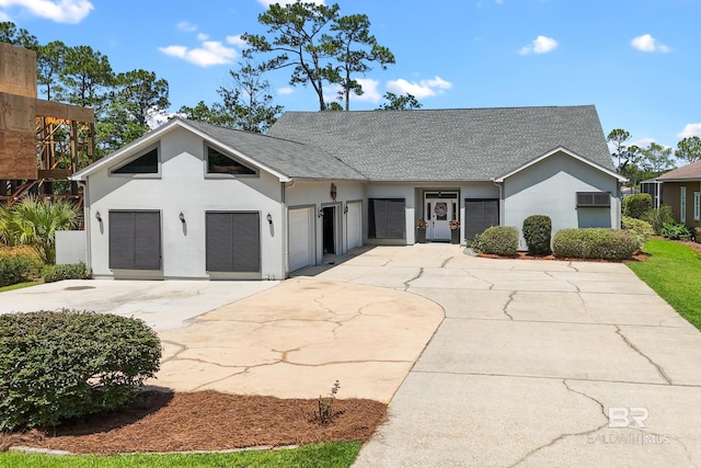 8585 Bay Harbor Rd, Elberta, AL 36530 - view of front facade with concrete driveway, stucco siding, roof with shingles, and a wall mounted air conditioner