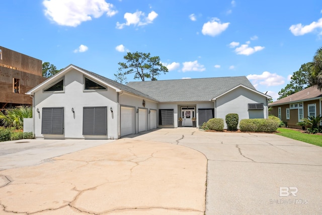 8585 Bay Harbor Rd, Elberta, AL 36530 - view of front of home featuring concrete driveway, stucco siding, and a garage