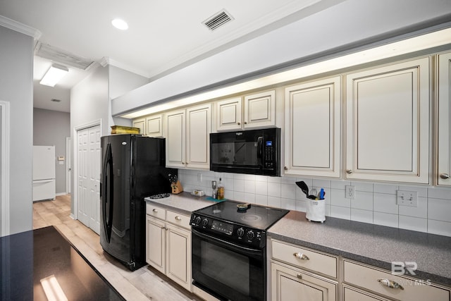 8585 Bay Harbor Rd, Elberta, AL 36530 - kitchen featuring black appliances, cream cabinetry, ornamental molding, and tasteful backsplash