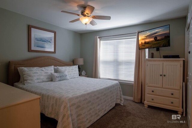 carpeted bedroom featuring ceiling fan and baseboards