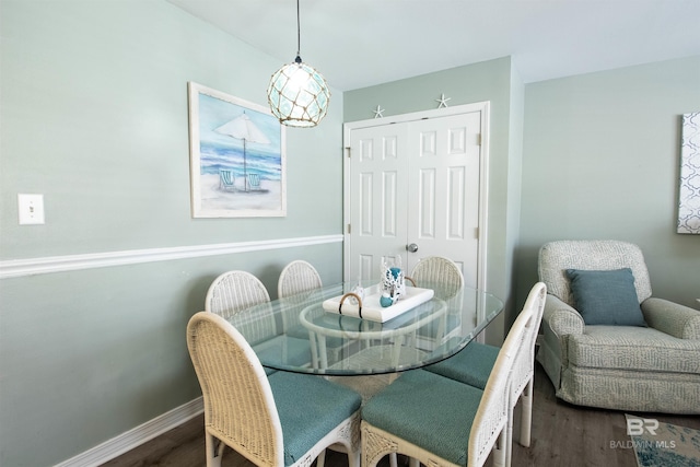 dining room featuring dark wood-style floors and baseboards