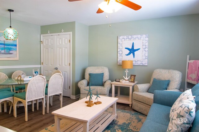 sitting room featuring a ceiling fan and wood finished floors