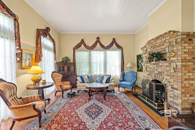 living room with a fireplace, crown molding, plenty of natural light, and wood-type flooring