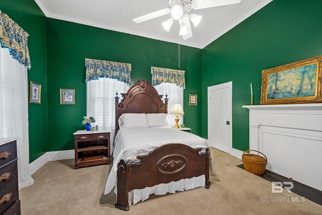 bedroom featuring ceiling fan, ornamental molding, and light carpet