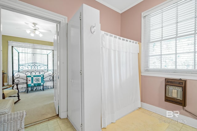 bathroom featuring heating unit, ceiling fan, and crown molding