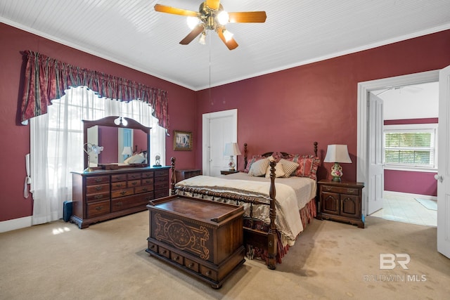 carpeted bedroom with ceiling fan and ornamental molding