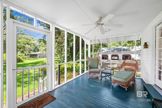 sunroom featuring ceiling fan