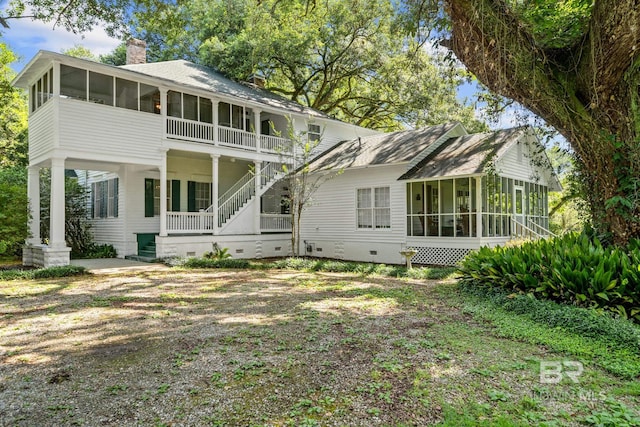 back of property with a sunroom