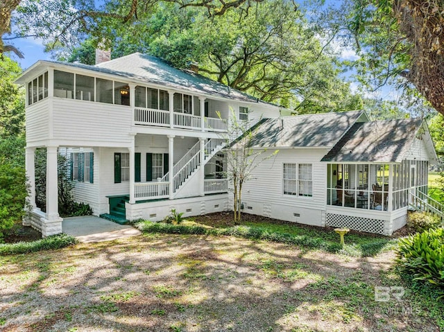 rear view of property featuring a sunroom