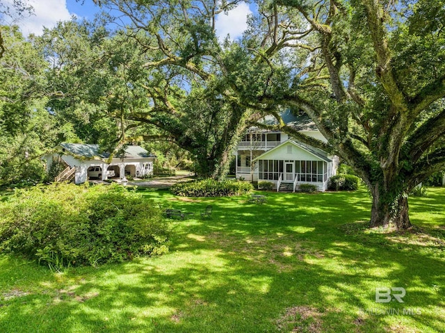 view of yard featuring a sunroom