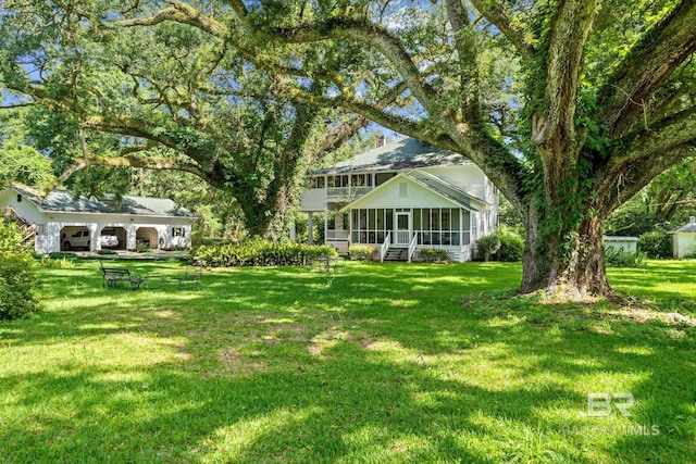 view of yard featuring a sunroom