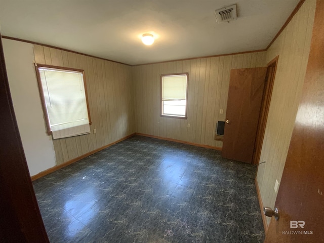 spare room featuring crown molding