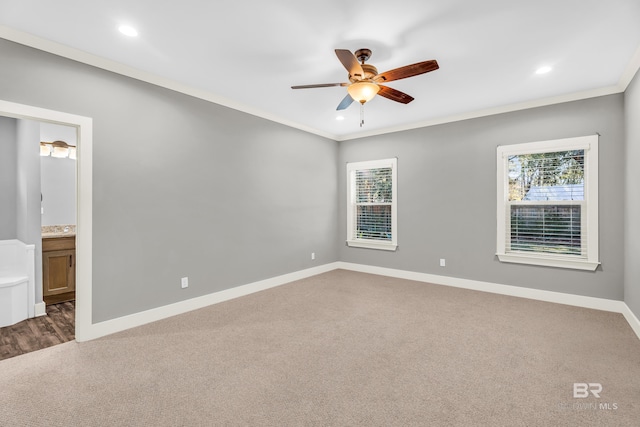 carpeted empty room featuring ceiling fan and crown molding