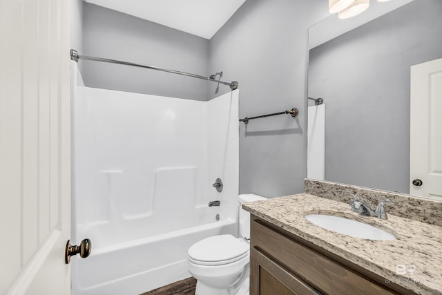 full bathroom featuring vanity, bathtub / shower combination, and toilet