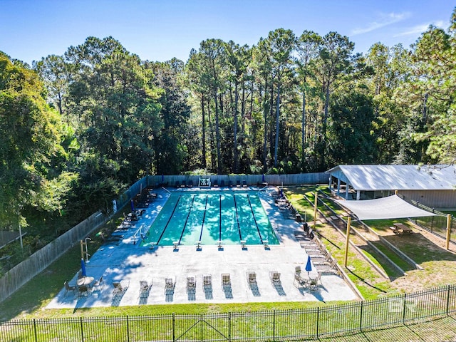 view of pool with a lawn