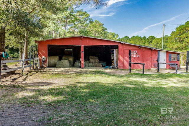 view of outbuilding with a lawn