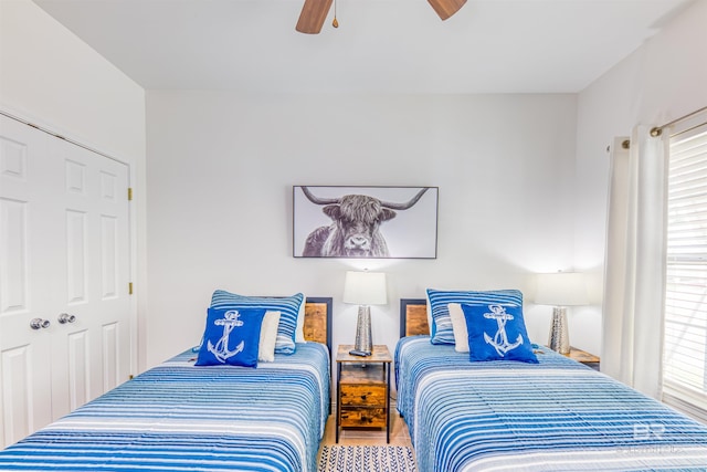 bedroom featuring wood-type flooring, ceiling fan, and a closet