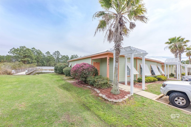 view of side of property featuring a pergola and a lawn