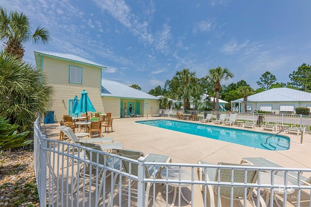 view of swimming pool featuring a patio area