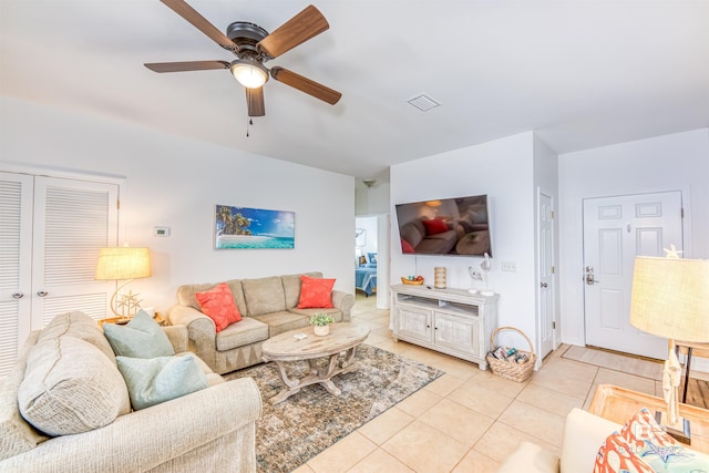 tiled living room featuring ceiling fan