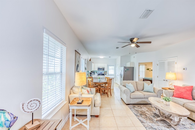 tiled living room featuring ceiling fan