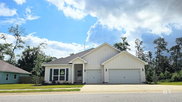 1897 Carly St, Foley, AL 36535 - view of front facade with a garage, concrete driveway, a shingled roof, and board and batten siding