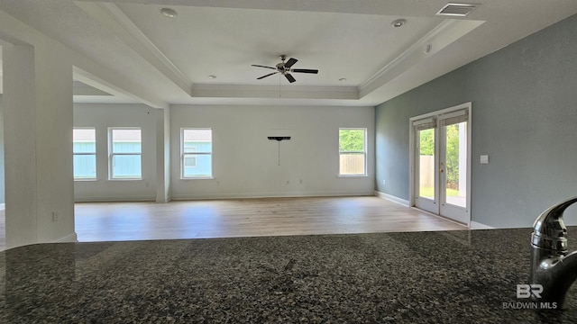 1897 Carly St, Foley, AL 36535 - unfurnished living room with a raised ceiling, wood finished floors, french doors, a ceiling fan, and healthy amount of natural light
