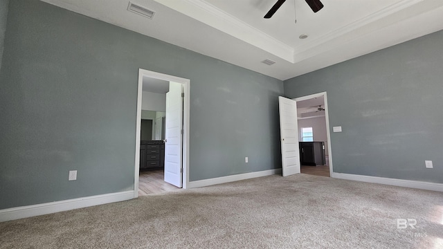 1897 Carly St, Foley, AL 36535 - unfurnished bedroom with carpet flooring, baseboards, ornamental molding, a tray ceiling, and ensuite bathroom