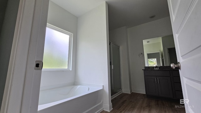 1897 Carly St, Foley, AL 36535 - full bathroom with vanity, a garden tub, wood finished floors, a stall shower, and baseboards