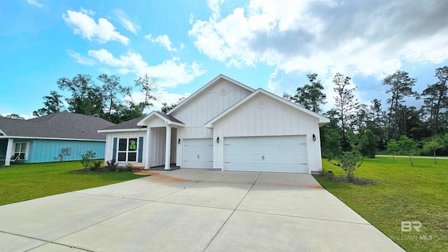 1897 Carly St, Foley, AL 36535 - view of front of home with concrete driveway, board and batten siding, a garage, and a front yard