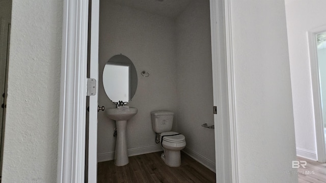 1897 Carly St, Foley, AL 36535 - bathroom featuring toilet, wood finished floors, and baseboards