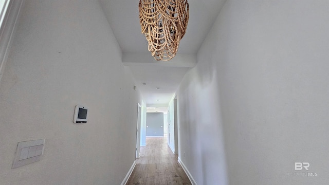 1897 Carly St, Foley, AL 36535 - hall featuring a chandelier, wood finished floors, and baseboards