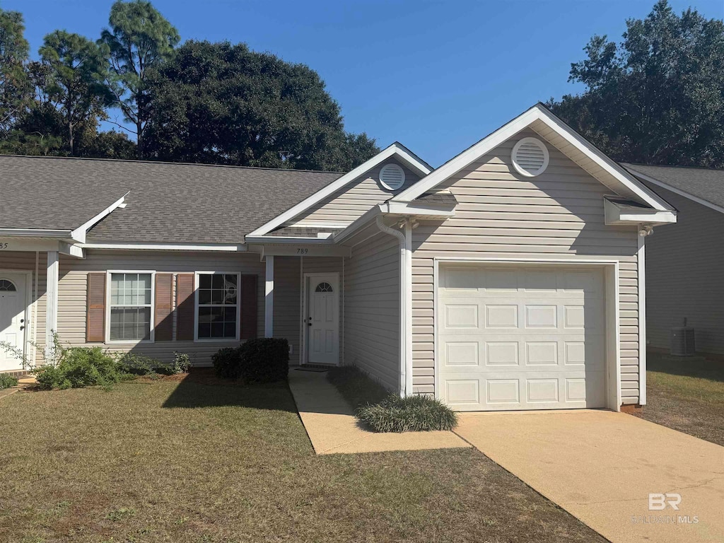 ranch-style home with a garage and a front yard