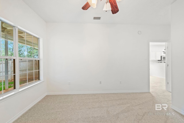 spare room with light carpet and ceiling fan