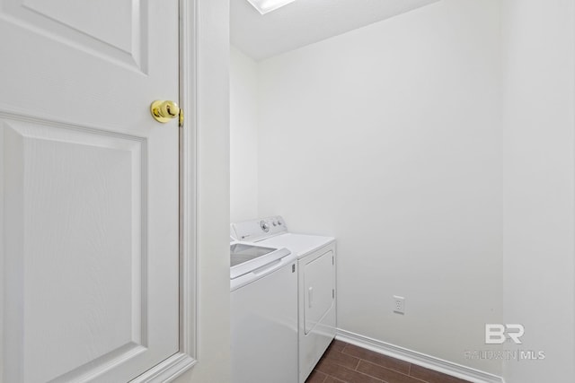 clothes washing area with dark hardwood / wood-style flooring and washer and clothes dryer