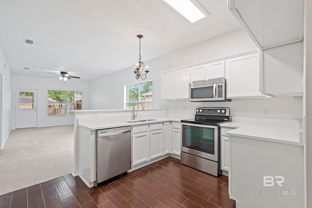 kitchen with white cabinetry, pendant lighting, sink, and stainless steel appliances