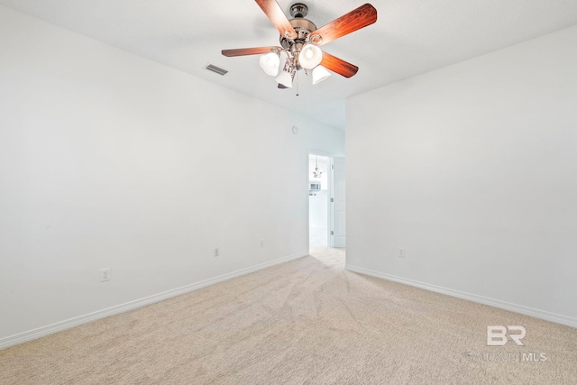 carpeted spare room with ceiling fan