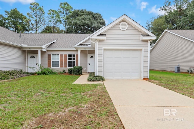 view of front of home featuring a front lawn, central air condition unit, and a garage