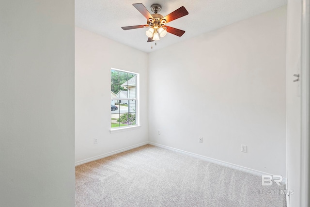 spare room featuring ceiling fan and light carpet